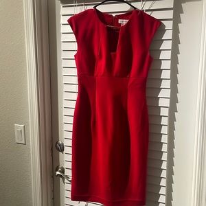Red Calvin Klein dress with gold neck accent.
